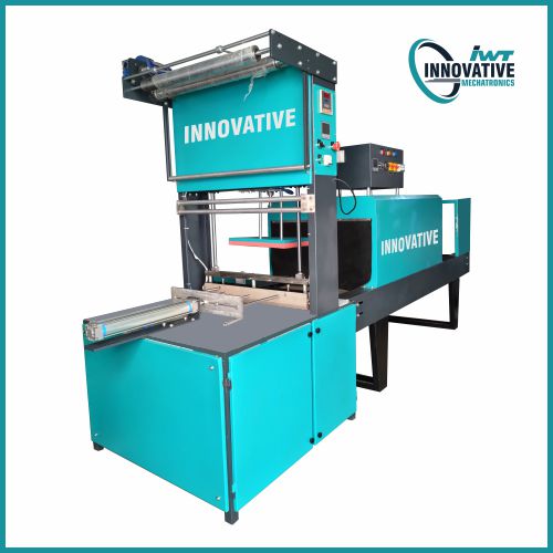 Industrial shrink wrap packaging machine wrapping bottles, cartons, and multipacks in heat-shrink film on a factory production line