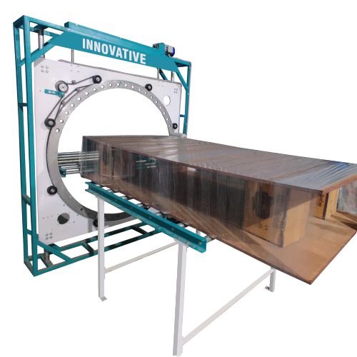Automatic packing machine wrapping solid door frames and edge bands with protective film in industrial packaging line