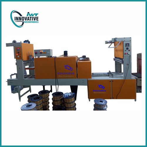 High-Speed Shrink Wrapping Machine by Innovative WrapTech Pvt. Ltd. in industrial packaging setup, showing conveyor-fed products with shrink film sealing and heat tunnel.